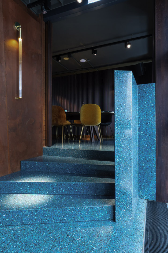 blue stairs made of terrazzo at Tuya Vienna