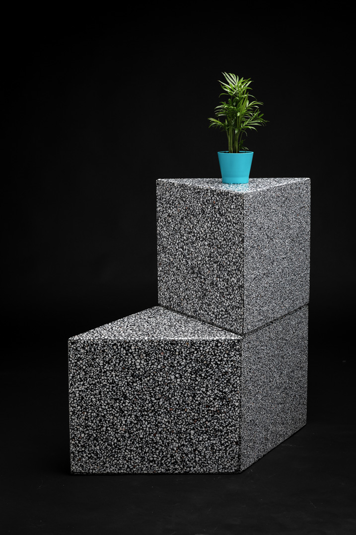 black terrazzo object with white marble chips