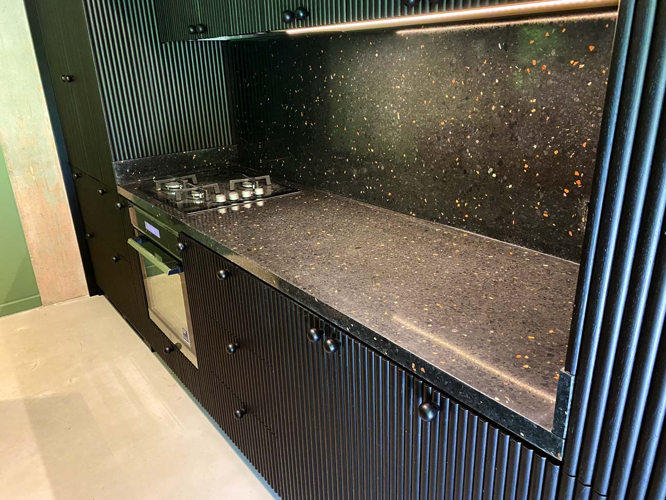 black kitchen with terrazzo